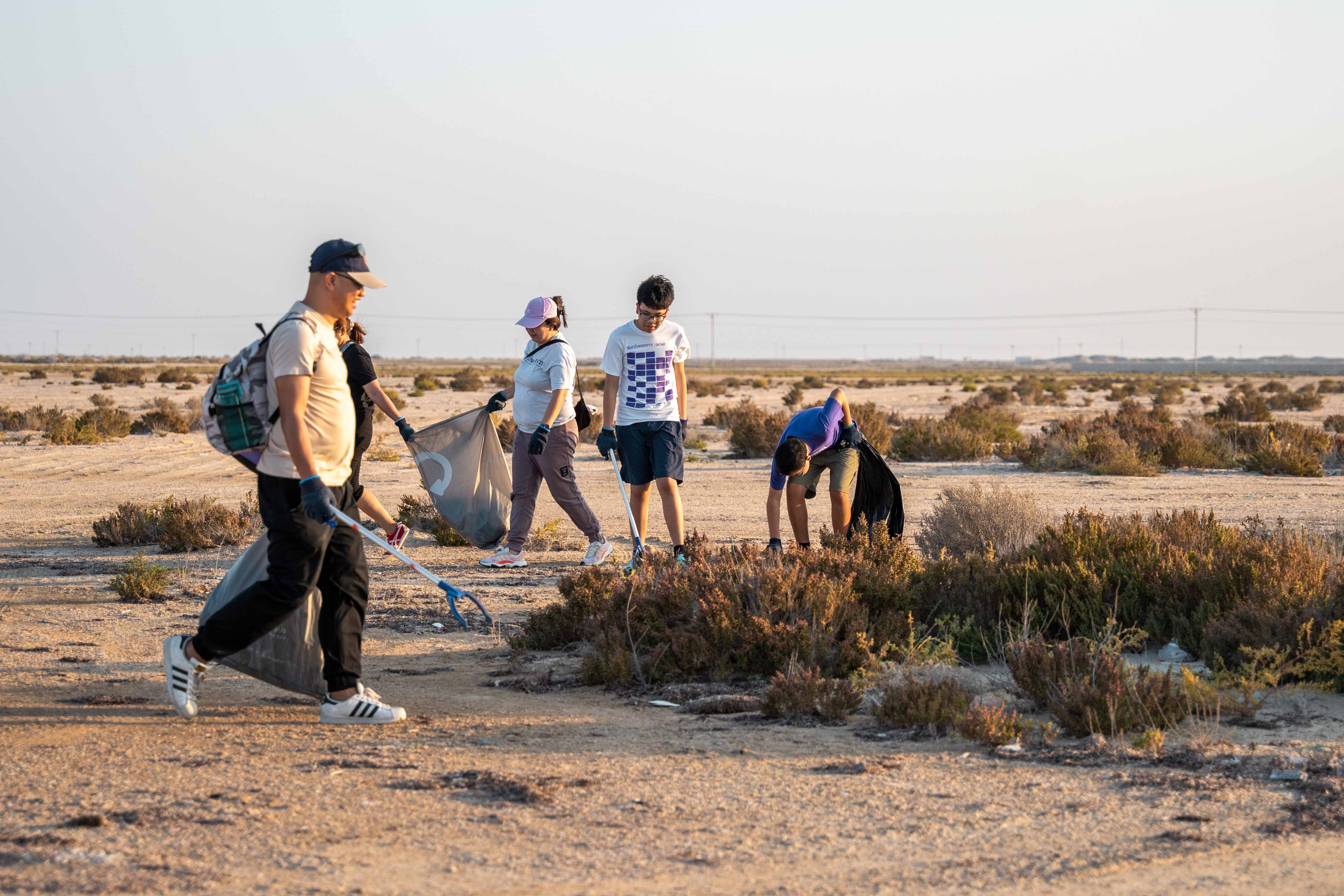 Students, faculty, and staff gather for a beach cleanup along Qatar’s coast, united in their commitment to environmental sustainability and community impact