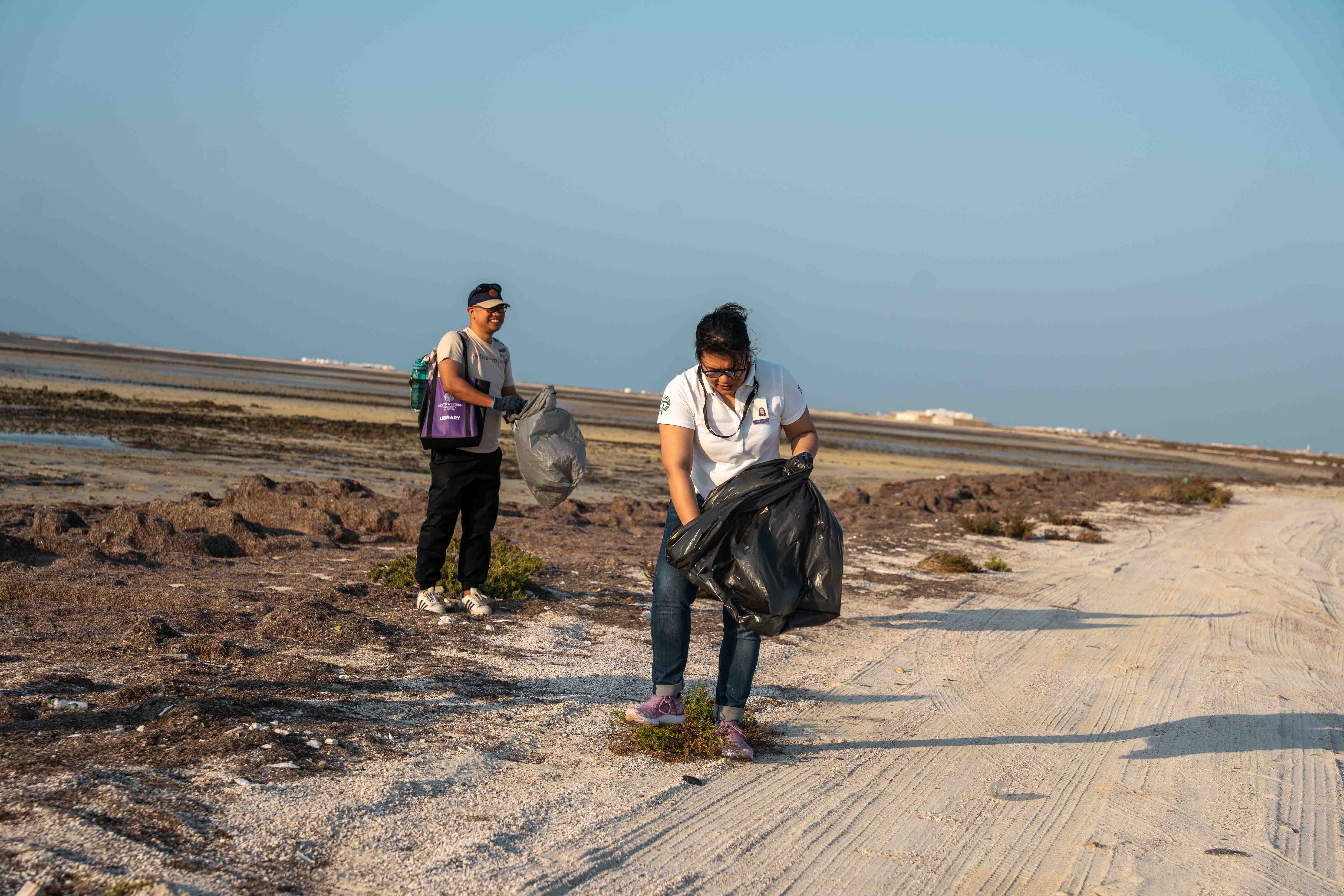 Participating members work together to remove debris along Qatar’s northeastern shore, supporting environmental sustainability and fostering unity