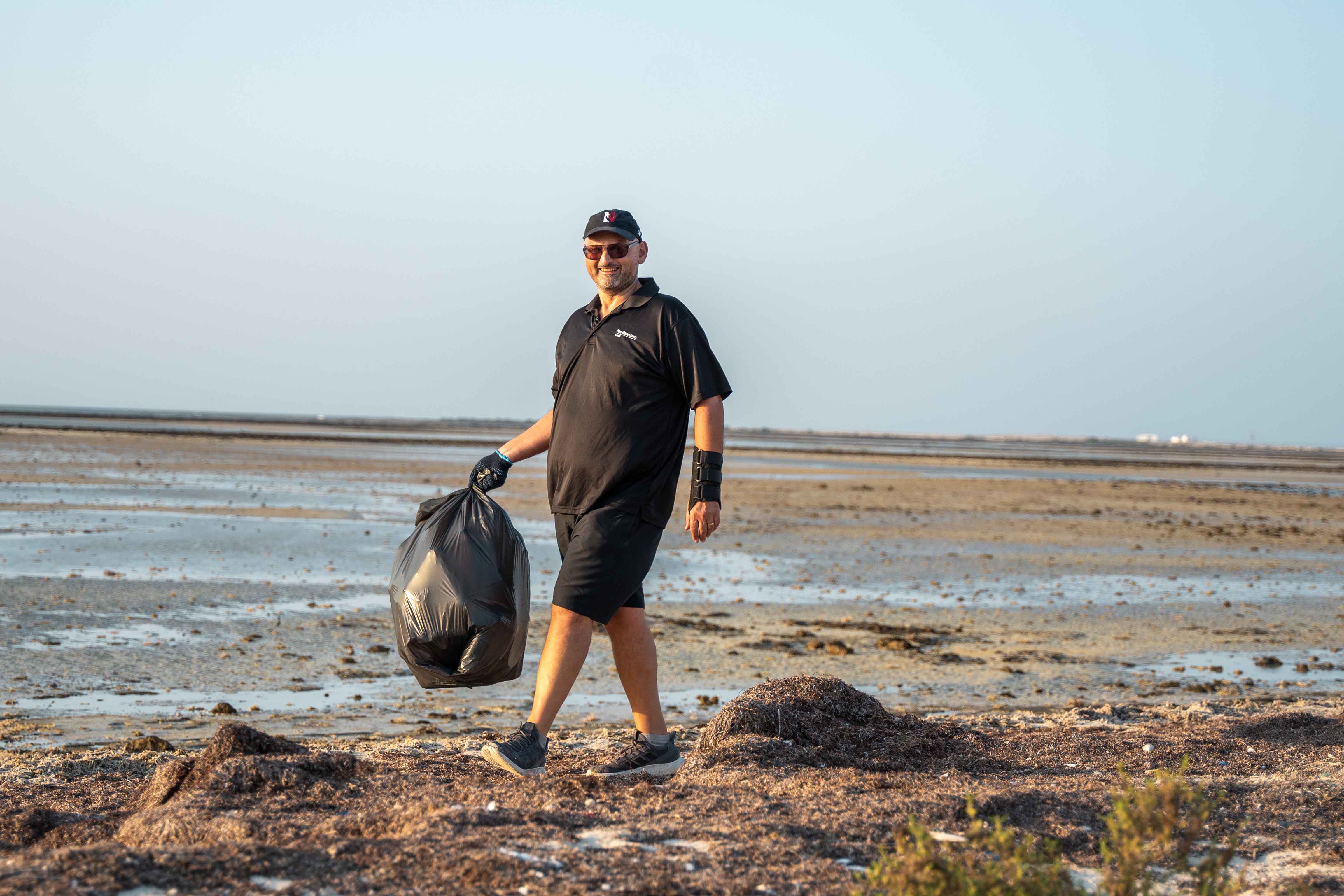 Dean Marwan M. Kraidy joins students, faculty, and staff in a coastal cleanup